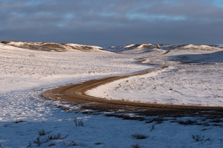 Winter Road Winding Into Hills