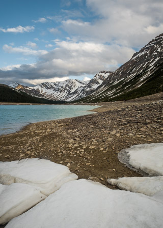 Snow Receding from Mountain Lake