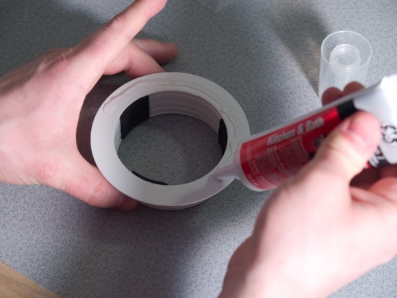Silicone the plexi-glass to the drain